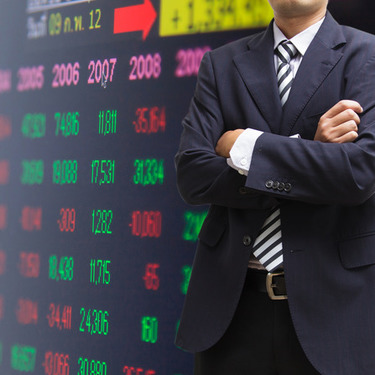 Image of Business Man and Stock Numbers