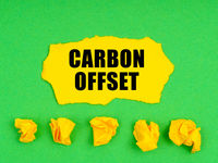 Crumpled%20yellow%20paper%20and%20a%20sheet%20with%20the%20inscription%20 carbon%20offset